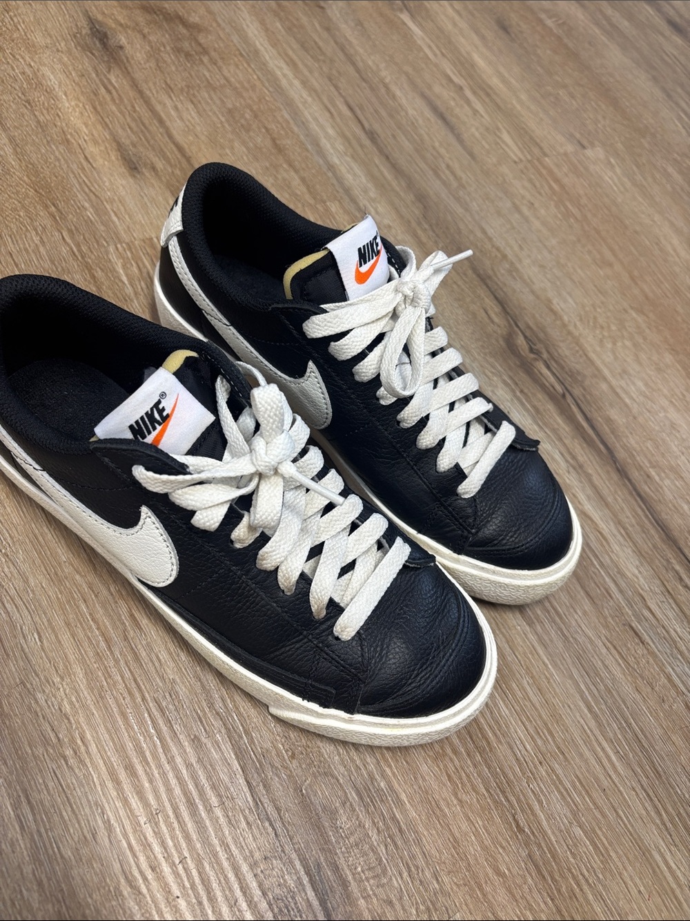 Nike Black Leather Low-Top Sneakers with White Swoosh gently used.